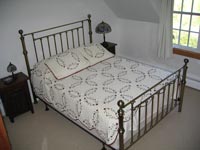 The queen bed in the Night Pasture bedroom.